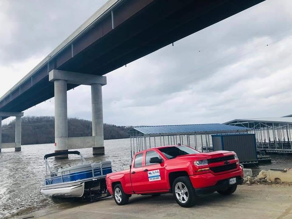 Big Daddy Boat Detailing truck and pontoon near Lake of the Ozarks water